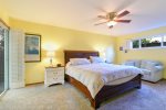 The large master bedroom has a king size bed and offers direct access to the back patio